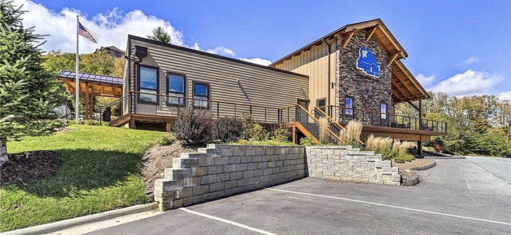Sugar Ski & Country Club clubhouse with stone entrance and mountain landscaping