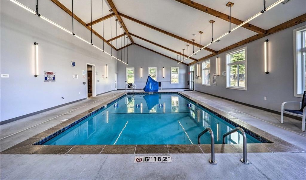 Indoor heated pool inside the Sugar Ski & Country Club clubhouse with vaulted wood-beam ceiling