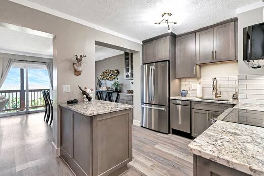 Renovated kitchen with granite counters and stainless appliances
